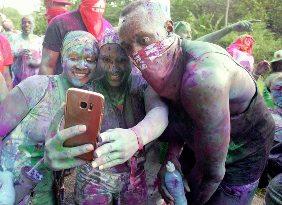 sain Bolt is covered in paint at amazing carnival party in Trinidad