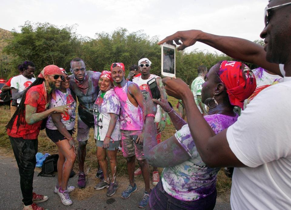 sain Bolt is covered in paint at amazing carnival party in Trinidad