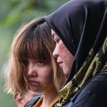 Two women charged with Kim's murder