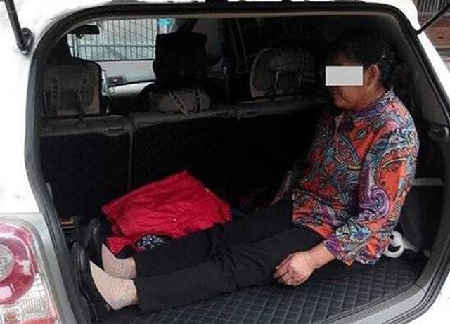 Photo Of Old Woman Sitting In Open Trunk While Son Drives Sparks Outrage