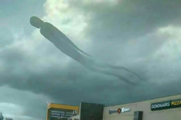 human-like figure appears in clouds above a shopping center 
