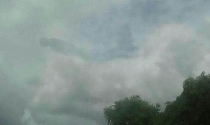 human-like figure appears in clouds above a shopping center 