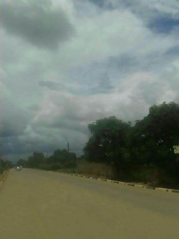 human-like figure appears in clouds above a shopping center 