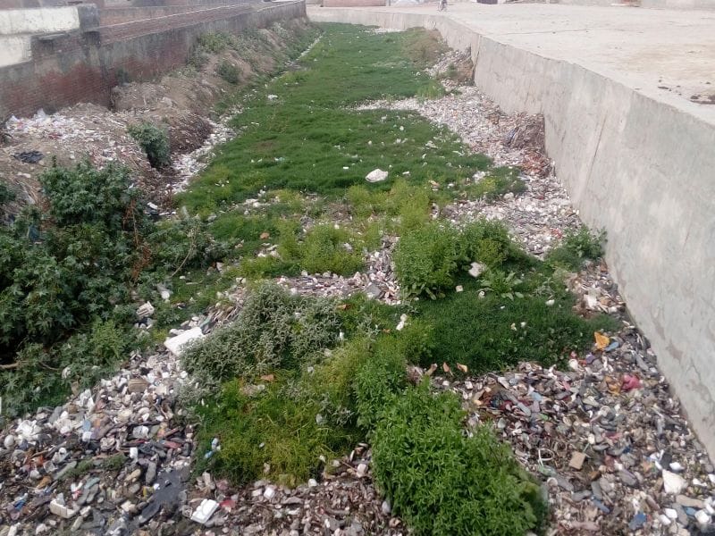 Dirt in the river downstream from the barrier