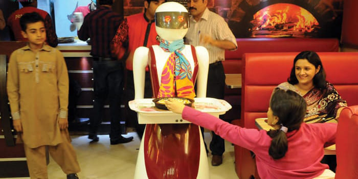 female robot serving food in Pakistani restaurant