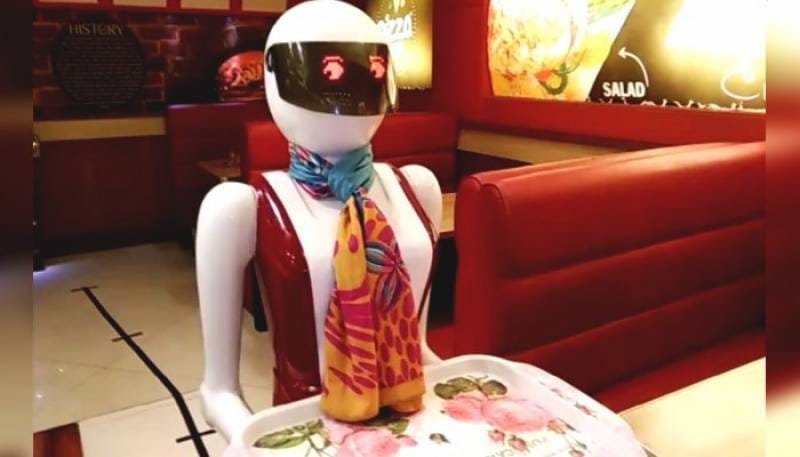 female robot serving food in Pakistani restaurant