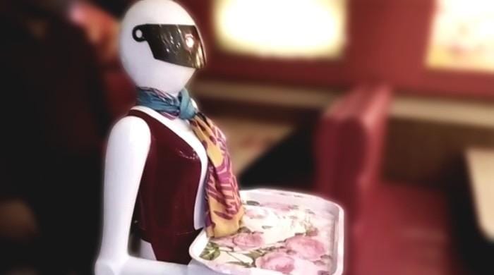 female robot serving food in Pakistani restaurant