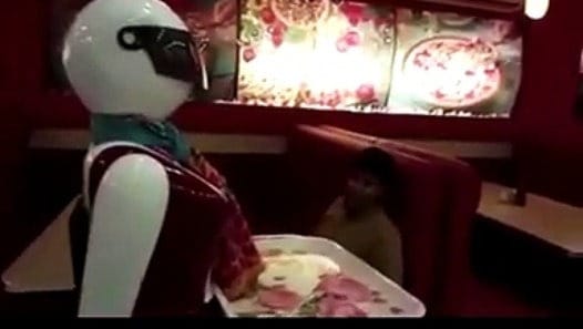 female robot serving food in Pakistani restaurant
