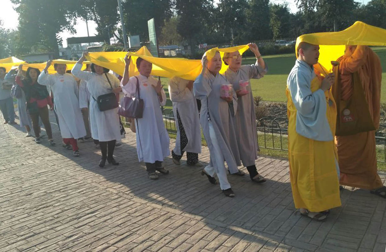 Chivr tourists plated Buddha statue