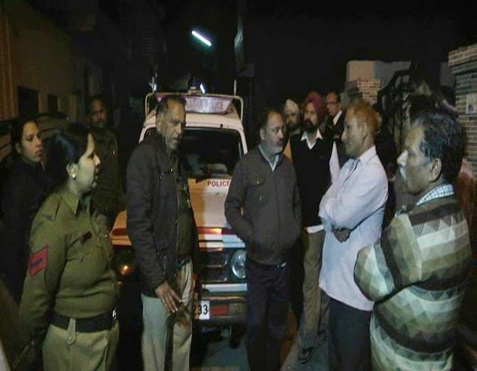 lady sit on protest with 5 month old child outside house against husband and in-laws