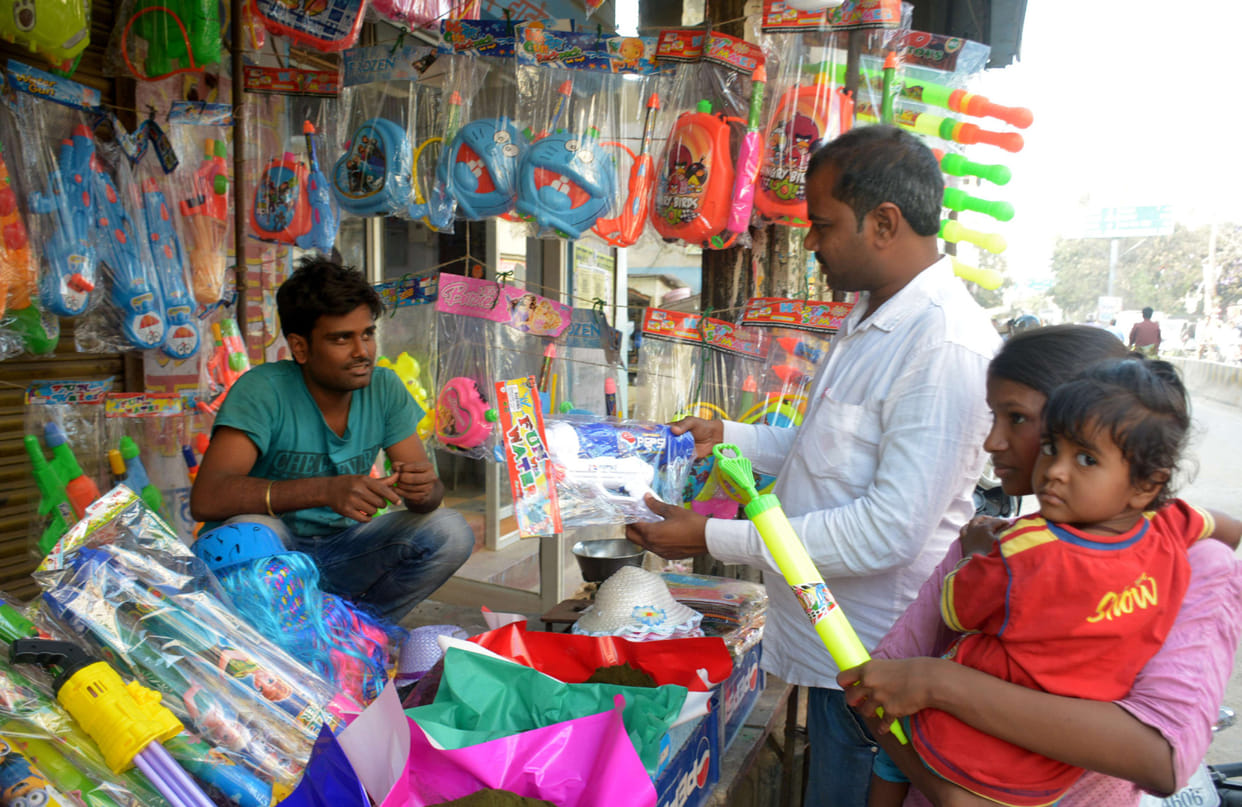 varanasi market is ready for holi, doremon at picjkaari