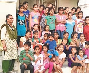Happy Holi by playing orphaned children with Holi