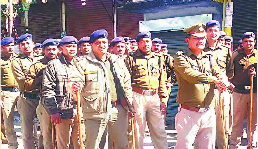 Police march flag in Baijnath, Garuda