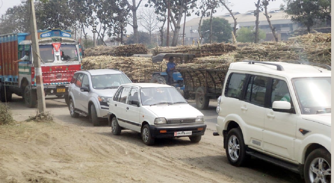 Overloaded cane vehicles and four-wheeler jam