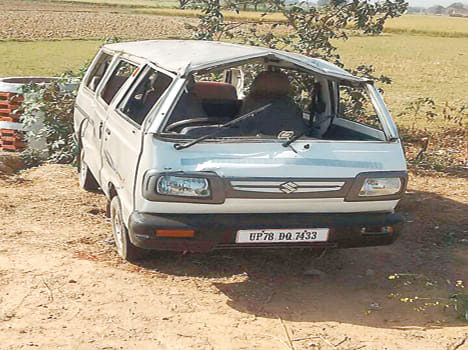 Tire bursts bend van, four injured