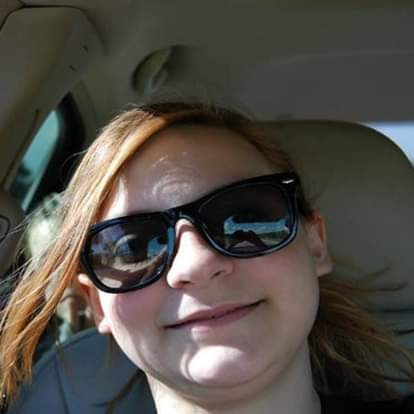 woman taking her selfie in car but there was also someone else