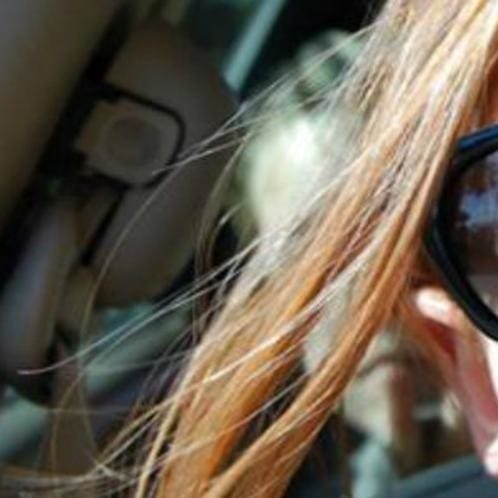 woman taking her selfie in car but there was also someone else