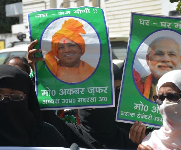  muslims protest with modi and yogi pictures.