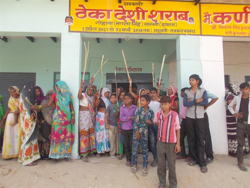 Women protesting against liquor contracts, pulled out of police