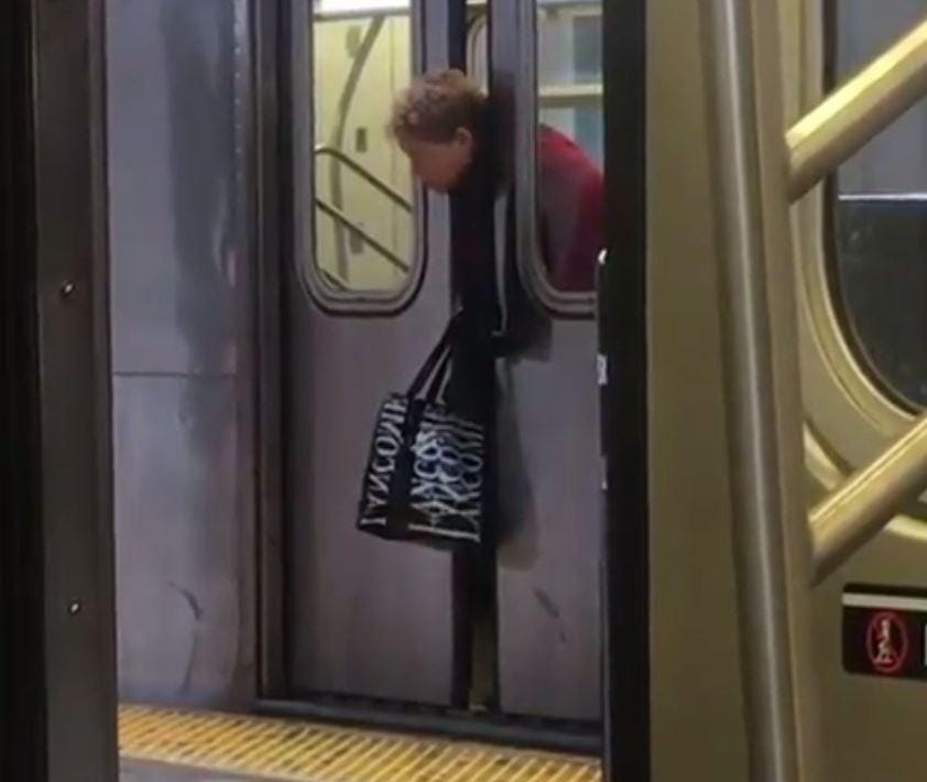 women head stuck in metro