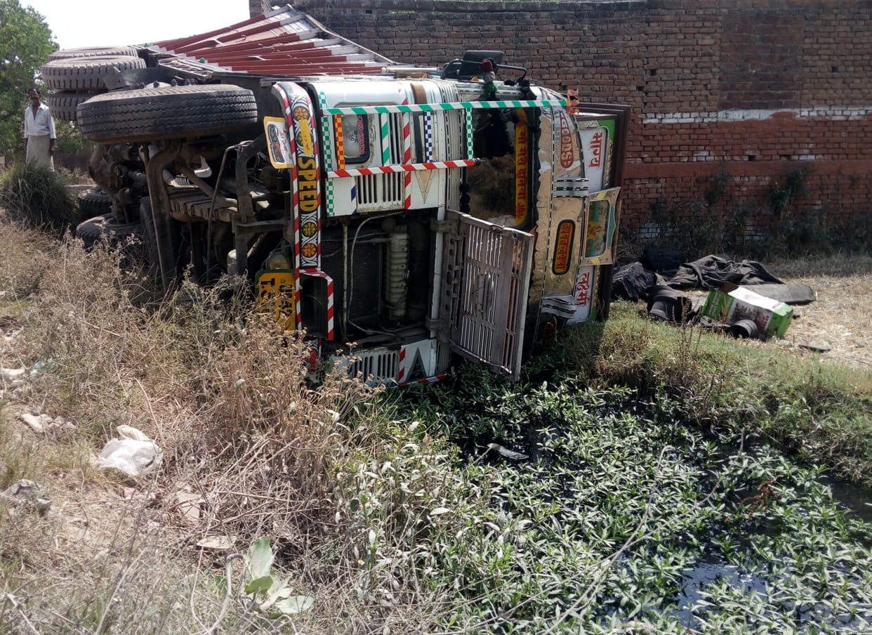 a truck turn over on road, furniture break