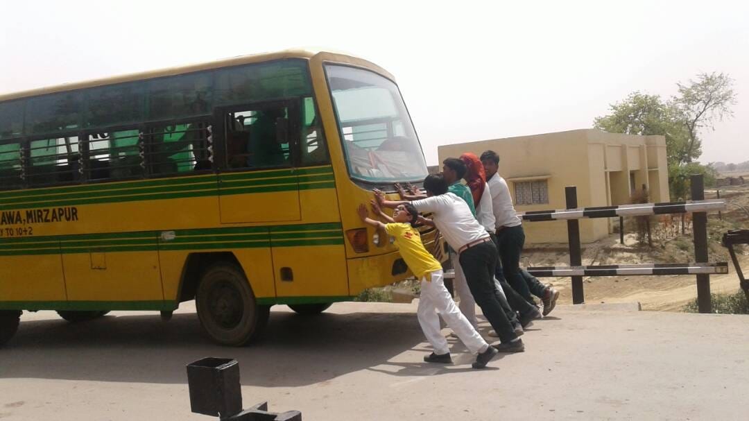 a schhol bus rifted in railway track at bhadohi