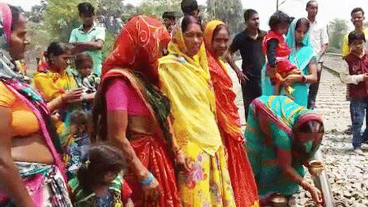 women in a village of Bihar worship railway track