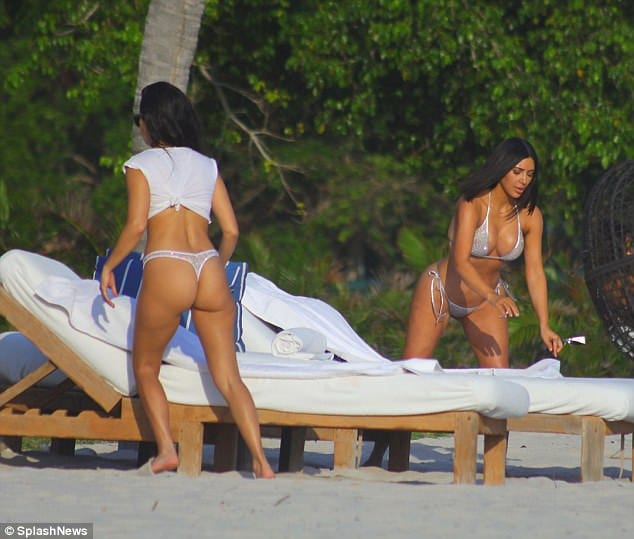 Kim and Kourtney Kardashian parade their beach bods in matching silver bikinis 