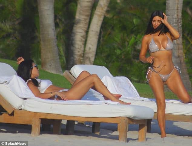 Kim and Kourtney Kardashian parade their beach bods in matching silver bikinis 