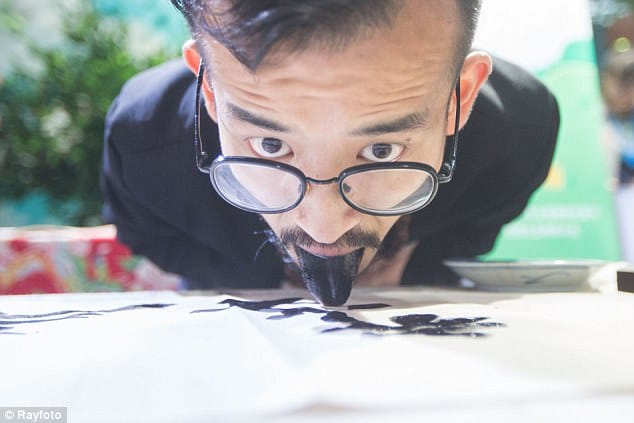Chinese artist creates ink paintings using TONGUE