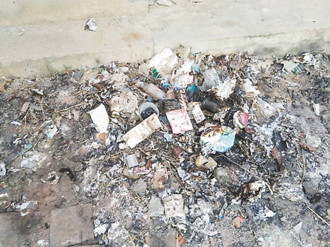 Burnt medicines, liquor vials in the litter pile