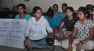 Girl students sitting on false grounds in support of students