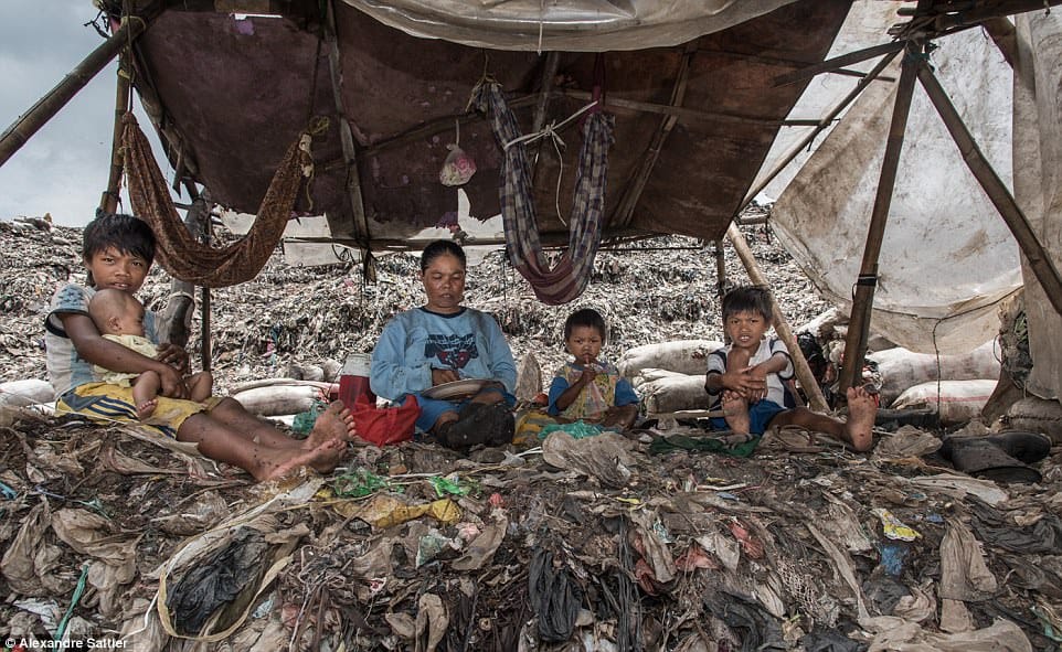 images reveal life inside a giant rubbish dump that’s home to 3,000 families  