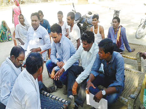 Villagers encircle the employees of electrifying company