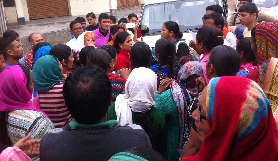 Agitating women surrounded the District Panchayat Chair.