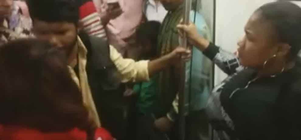 african woman removes her cloth in delhi metro, video goes viral