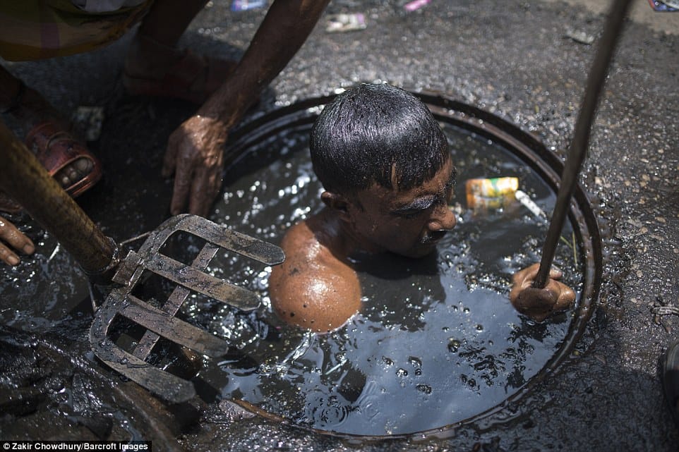 Bangladesh sewer cleaner has to dive into liquid filth to clean blockage