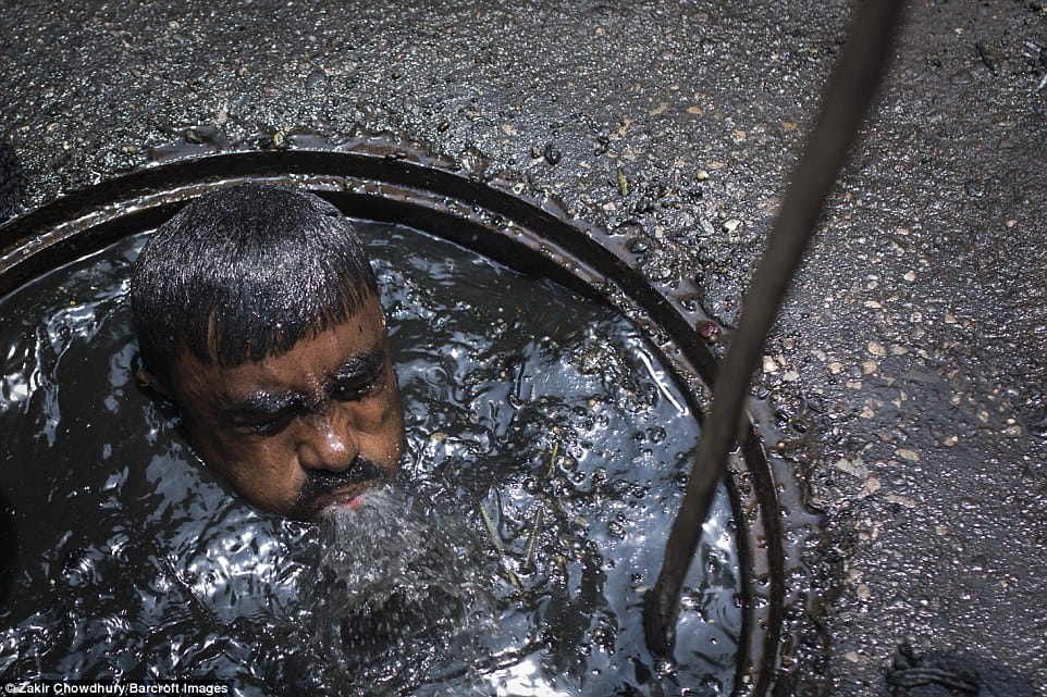 Bangladesh sewer cleaner has to dive into liquid filth to clean blockage