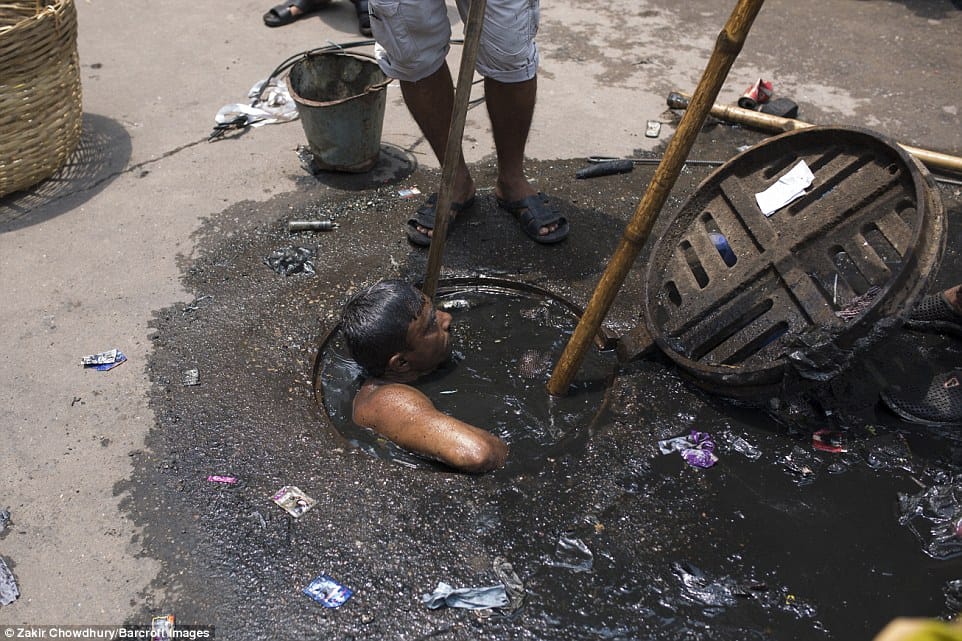 Bangladesh sewer cleaner has to dive into liquid filth to clean blockage