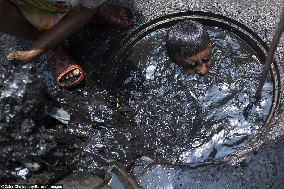 Bangladesh sewer cleaner has to dive into liquid filth to clean blockage