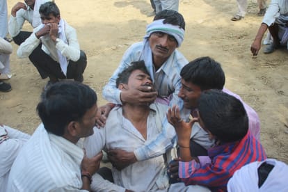 people mourning in the village of agra after death of 14 men