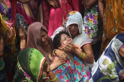 people mourning in the village of agra after death of 14 men