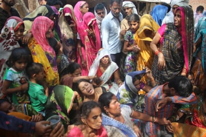 people mourning in the village of agra after death of 14 men