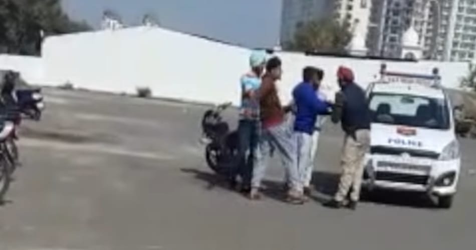 video of policemen being thrashed on road by boys goes viral
