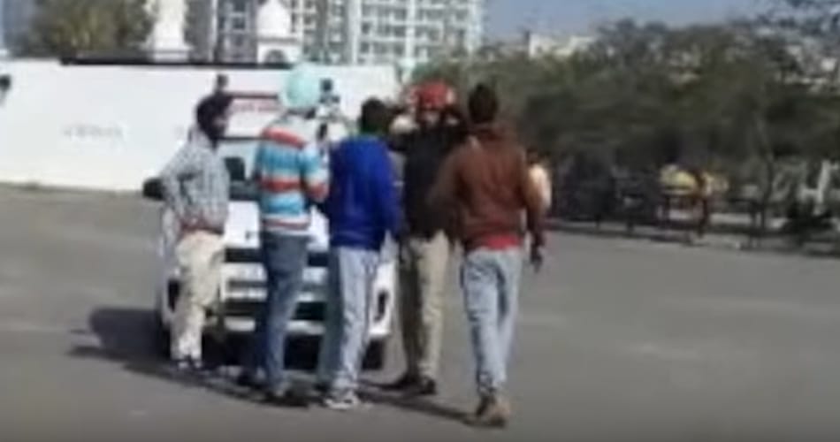 video of policemen being thrashed on road by boys goes viral