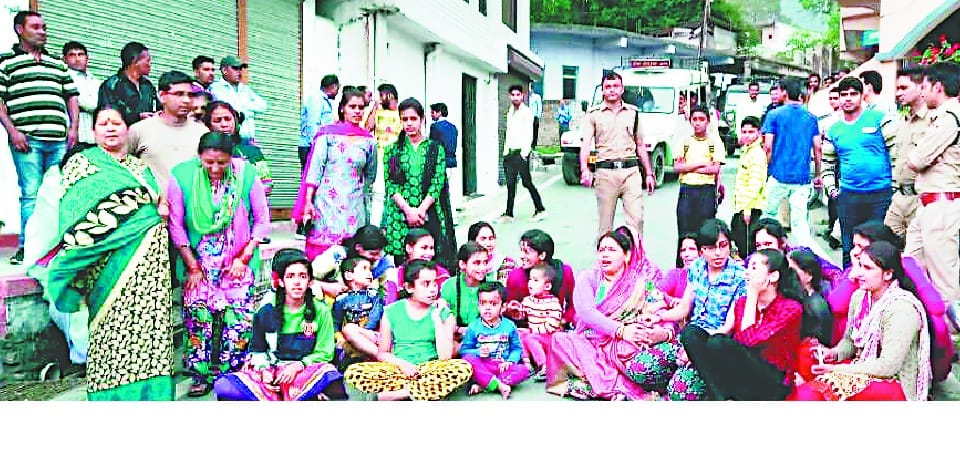 Women and children straped with scorpion grass in hand