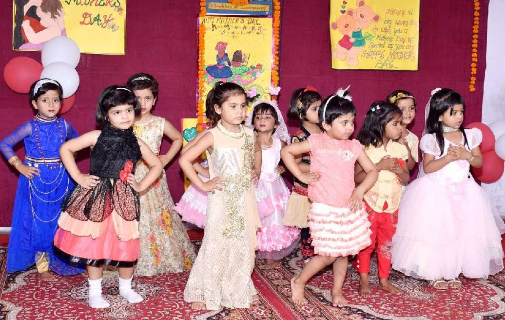 Mothers celebrate by offering children dance