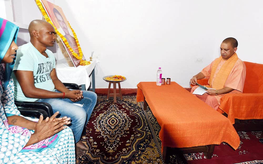 शहीद के परिवार से मिलते योगी, फर्श पर बिछी कालीन