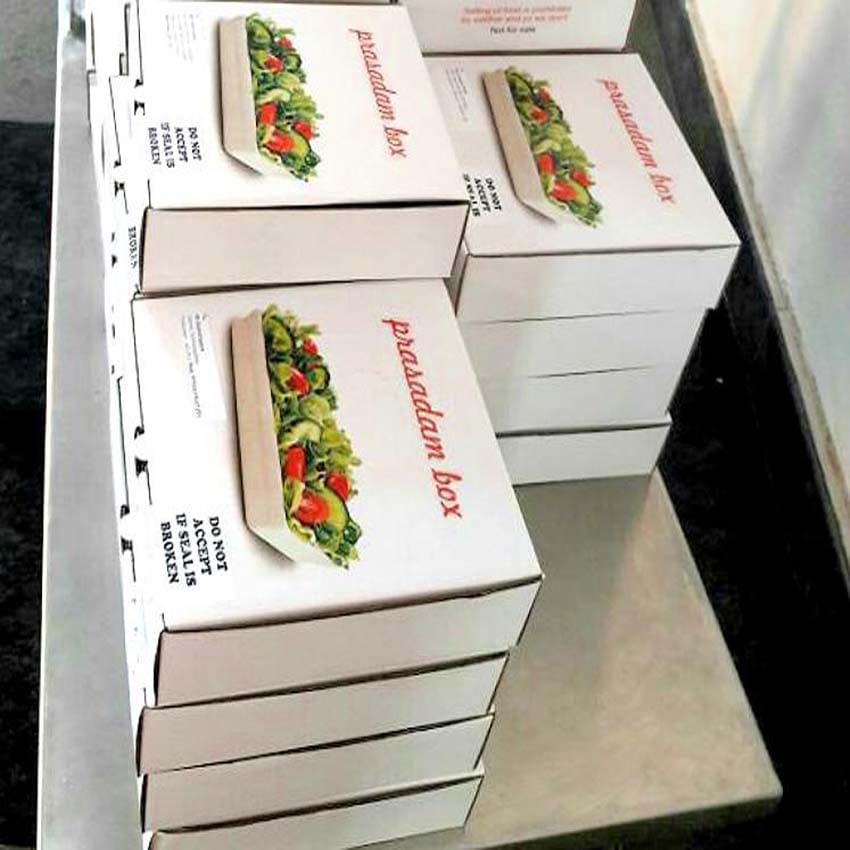devotees get burger and cake with mineral water as prasadam