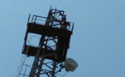 a student climb in tower in dehradun for his demand